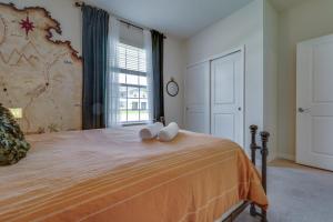 a bedroom with a bed with two towels on it at Windsor Island Resort 5 Bedroom Townhome Private Pool Disney in Davenport +47 photos