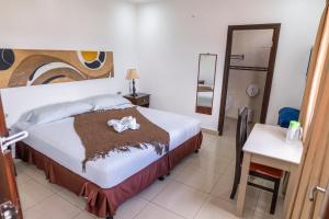 a bedroom with a bed with a flower on it at Hotel Santa Fe in Santa Rosa de Copán