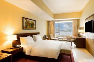 a hotel room with a bed and a large window at Radisson Blu Anchorage Hotel in Lagos