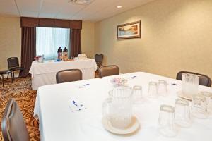 a conference room with white tables and chairs at Holiday Inn Express & Suites Southern Pines-Pinehurst Area by IHG in Southern Pines +26 photos
