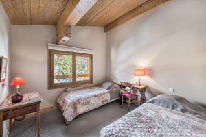 a bedroom with two beds and a window at L'Écrin Alpin - Welkeys in Megève