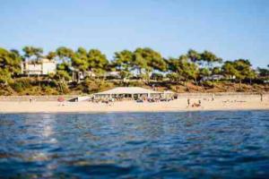 a beach with a tent and people on the beach at Bel appartement bord de mer 4 pers Arcachon centre in Arcachon