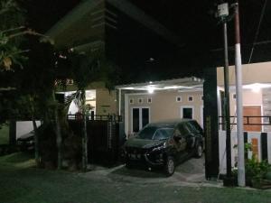 a car parked in front of a house at night at Puri Garden Batu in Batu