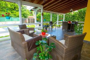 a patio with wicker chairs and a table with a table at The Doctor's House in Sapanca