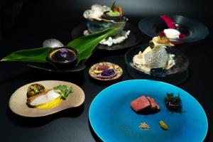 a group of plates of food on a table at kānusuba zamami in Zamami