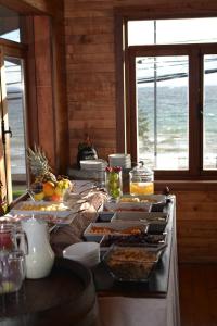 a long table with plates of food on it at Puerto Chico Hotel in Puerto Varas