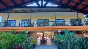 a large building with a balcony with plants at Myoldhouse in Lahad Datu