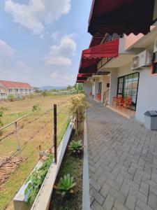 a building with a fence next to a field at Hotel Griya Wijaya in Ambarawa