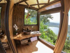a bathroom with a sink and a large window at Casa maar -Treetop tent in Río Cuarto +21 photos