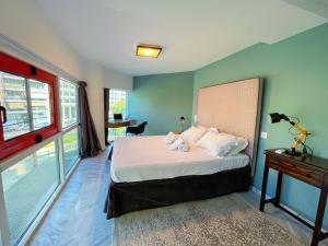 a bedroom with a bed and a table with a lamp at WSD Baia Acropolis Hotel Apartment in Athens