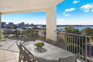 a balcony with a table with a bowl of fruit on it at Rovera Apartments in Maroochydore
