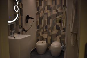 a bathroom with a sink and a toilet and a mirror at Federico 70 Zaffiro Luxury in Palermo