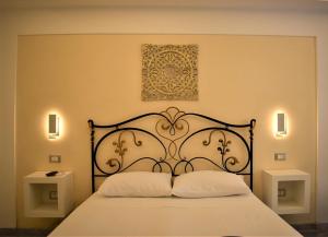 a bedroom with a black bed with two pillows at Federico 70 Zaffiro Luxury in Palermo