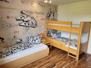 two bunk beds in a room with a wall with drawings at Ferienwohnung Bergpanorama mit Pool in Sankt Englmar