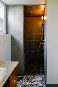 a bathroom with a shower and a sink at Studio on Capri in Calgary