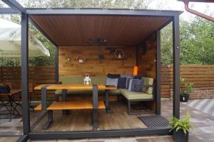a gazebo with a table and chairs on a patio at Gizella vendégház in Odorheiu Secuiesc