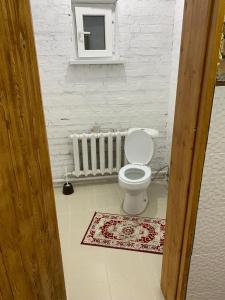 a white bathroom with a toilet and a window at Kolsay Aisha in Saty +55 photos