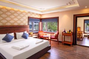 a bedroom with a bed and a desk and a room at ANGKASA LADAKH RESORT in Leh