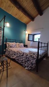 a bedroom with a bed with a tv on the wall at La Casina de Piedra ENCANTO - Parte Antigua de Cáceres in Cáceres