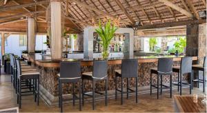 a bar in a restaurant with chairs and a counter at Villas Mon Plaisir in Pointe aux Piments