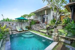 a swimming pool in the yard of a house at KTS Balinese Villas in Canggu
