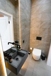 a bathroom with a sink and a toilet at Suite Hotel in Kemerovo