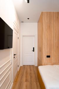 a bedroom with a bed and a white door at Suite Hotel in Kemerovo