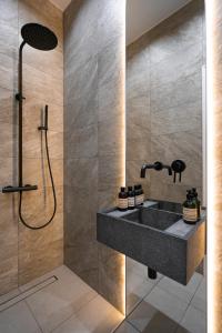 a bathroom with a sink and a shower at Suite Hotel in Kemerovo