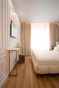 a bedroom with a bed and a table and a window at Suite Hotel in Kemerovo