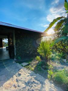 a stone house with the sun setting behind it at Finca Completa - Casa Privada - Vía Bogotá - La Mesa con WIFI - Pet Friendly in La Mesa