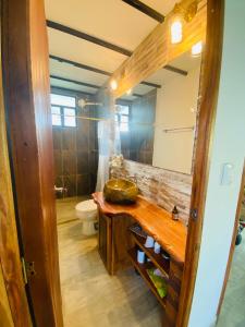 a bathroom with a sink and a toilet and a mirror at Finca Completa - Casa Privada - Vía Bogotá - La Mesa con WIFI - Pet Friendly in La Mesa