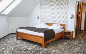 Postel nebo postele na pokoji v ubytování Hotel Horal