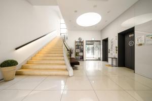 a hallway with stairs in a building at Crown Hotel Changwon in Changwon