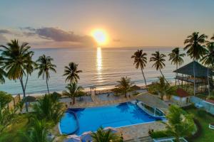 an aerial view of a resort with a pool and the ocean at Sunny Palms Beach Bungalows in Uroa