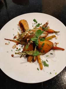 a plate of food with carrots on a table at Orange Hotel La Louvière in La Louvière