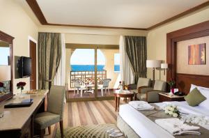 a hotel room with a bed and a balcony at Charmillion Club Resort in Sharm El Sheikh
