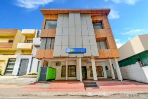 a building with a sign on the front of it at FabExpress PAS Residency - Nr Marina Beach in Chennai