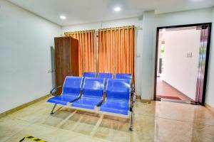 a group of blue chairs in a room at FabExpress PAS Residency - Nr Marina Beach in Chennai
