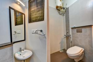 two images of a bathroom with a toilet and a sink at FabExpress PAS Residency - Nr Marina Beach in Chennai