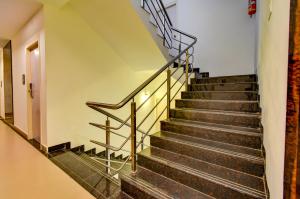 a staircase with metal railings in a building at FabExpress PAS Residency - Nr Marina Beach in Chennai