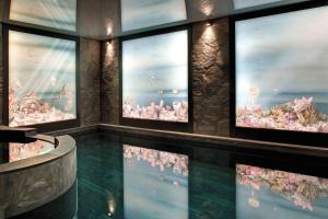 a room with a large aquarium with fish in it at La Demeure Montaigne in Paris