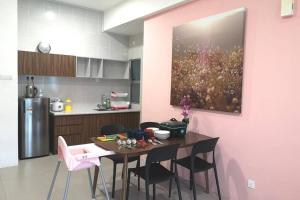 a kitchen with a table with chairs and a painting on the wall at W58 WarmStay atGoldenHill NightMarket 2R WiFi CarPark in Tanah Rata