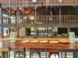 a wooden table with plates of food on top of it at Villapadu Desa in Kuala Terengganu