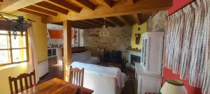 a living room with a couch and a table at CORRAL DEL PRAJONCILLO in Valdecasa