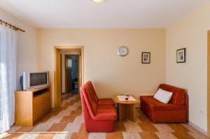 a living room with two chairs and a television at Two-Bedroom Apartment Crikvenica 19 in Dramalj