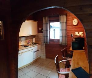 an archway in a kitchen with a table and a clock at Blockhaus - Die Zwergenbaude - in Braunlage