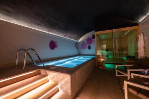 a swimming pool in a room with a house at Sant Jaume Design Hotel in Palma de Mallorca