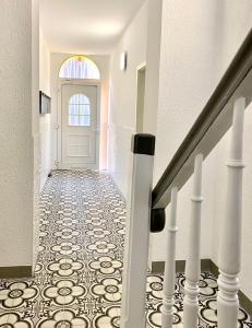 a hallway with a white door and a tile floor at RÜ Business Apartments & Suites in Essen
