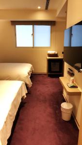 Postel nebo postele na pokoji v ubytování Michi Hotel - Luodong