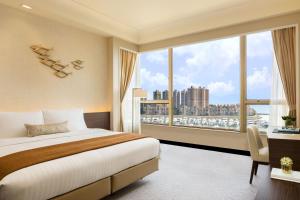 A bed or beds in a room at Hong Kong Gold Coast Hotel